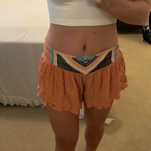 Flowy orange shorts with sewn detailing